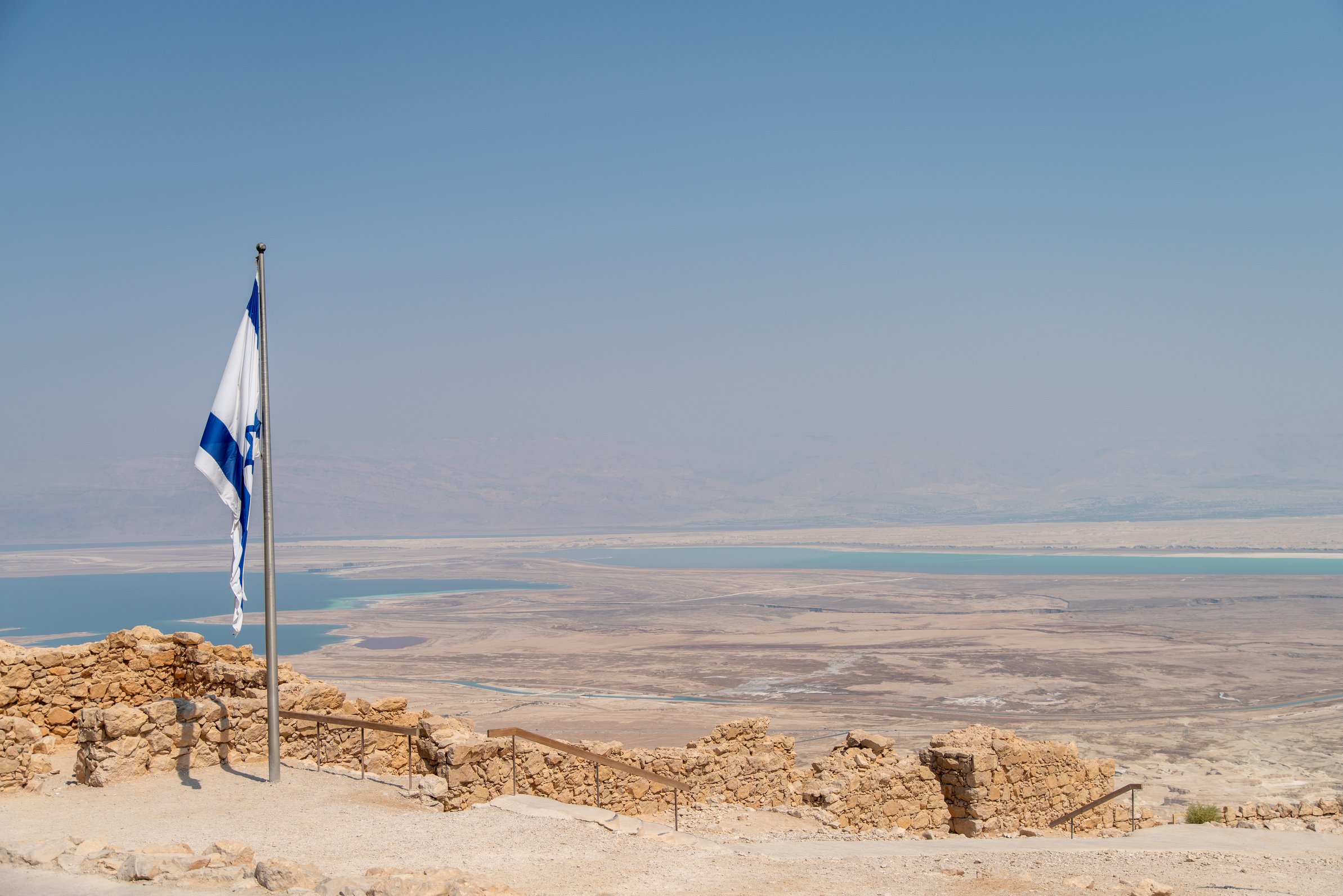 View of The Israeli Flag on Top of Massada With the Dead Sea in the Background